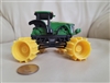 Vintage John Deere mini road roller toy with green metal top and black plastic undercarriage