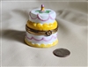 Trinket box porcelain cake with gold tone border.